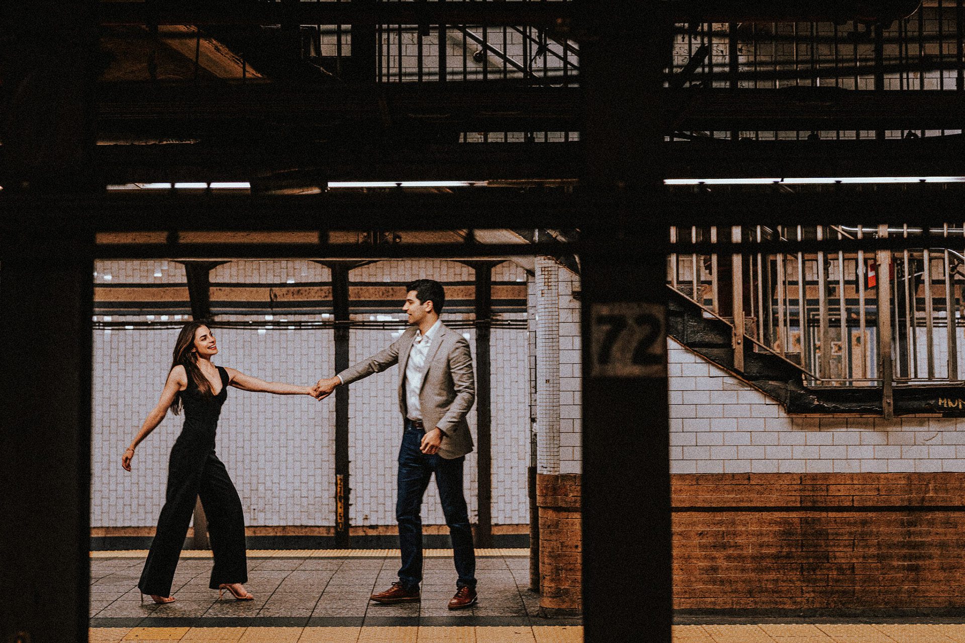A engagement couple dancing in the subway station in NYC.