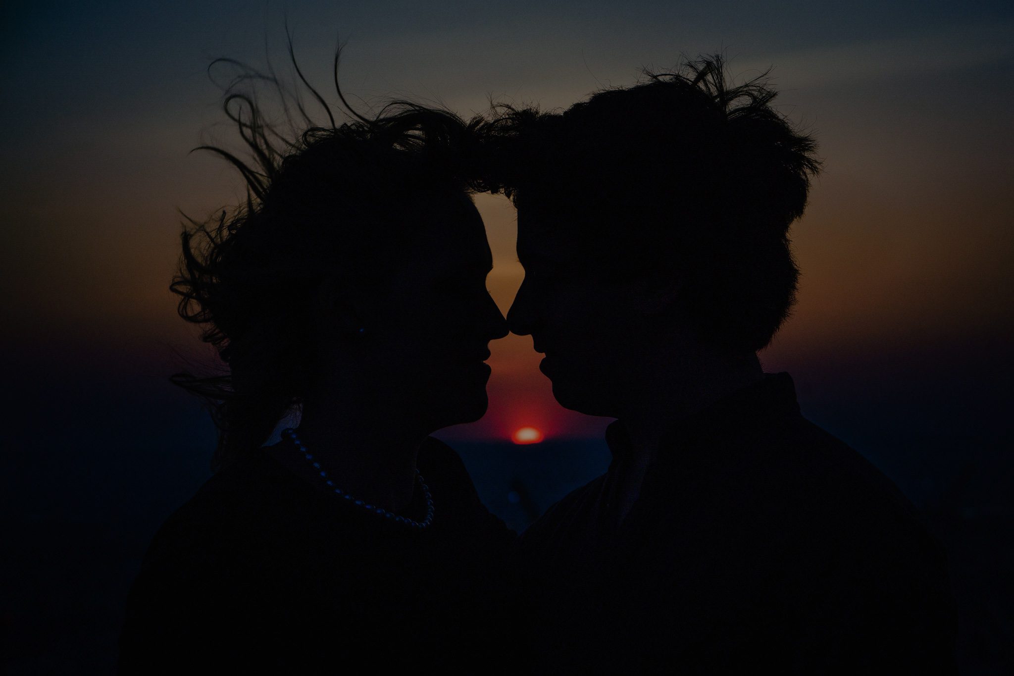 Cinematic fine art engagement silhouette at sunset, capturing the couple’s intimate profile and authentic connection in dramatic natural light — Resonance Vision engagement photography.